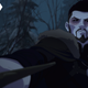 Vesemir (Theo James), eyes blackened by magical, poisonous potions, draws his sword in a snowy forest.